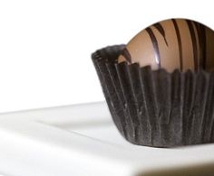 a chocolate egg sitting on top of a white plate