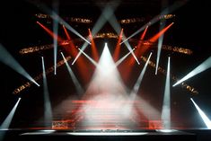 several spotlights are shining brightly on a stage