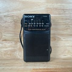 an old radio sitting on top of a wooden table