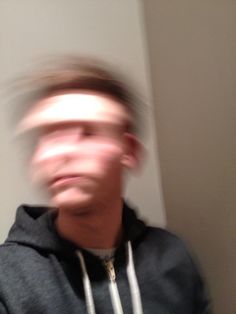 a blurry photo of a man in a hoodie