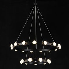 a circular chandelier with eight lights hanging from it's center, on a black background