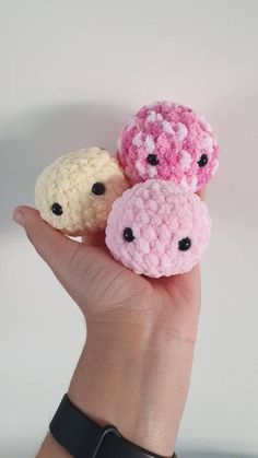 three small crocheted animals sitting on top of each other in someone's hand