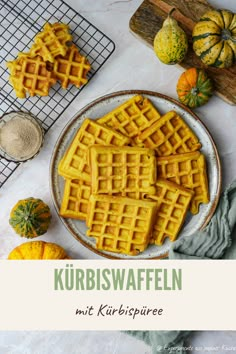 waffles on a plate with pumpkins in the background and text overlay that reads kurbiswaffen