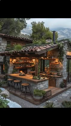 an outdoor kitchen with stone walls and roof