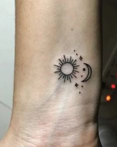 a small sun and moon tattoo on the ankle