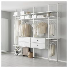 an organized white closet with clothes and shoes