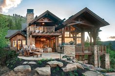 a large house sitting on top of a lush green hillside