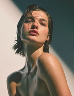 a woman with wet hair and no shirt on