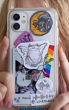 a person holding up a cell phone case with pictures and magnets attached to it