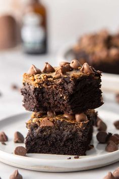 two chocolate brownies stacked on top of each other with peanut butter and chocolate chips