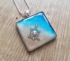 a glass pendant with a turtle on it