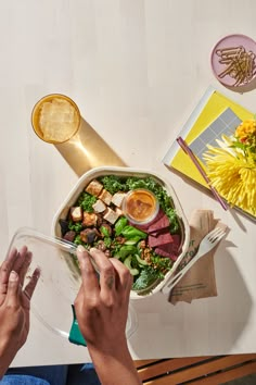 a person sitting at a table with a bowl of food