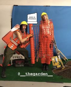 two construction workers are posing for a photo