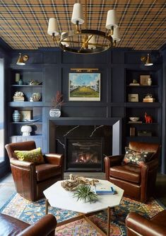 a living room filled with furniture and a fire place under a chandelier above a fireplace