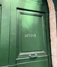 a green door with the word amovr written on it