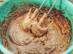 a mixing bowl filled with batter and chocolate