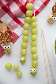 grapes with googly eyes and pretzels on sticks