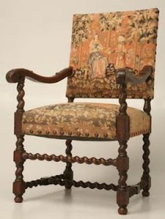 an old fashioned chair with floral upholstered back and arm rests against a white background