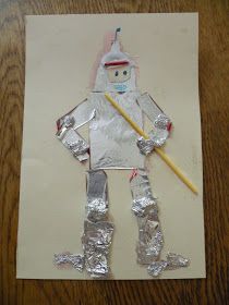 an art project made out of aluminum foil with a stick in the shape of a man