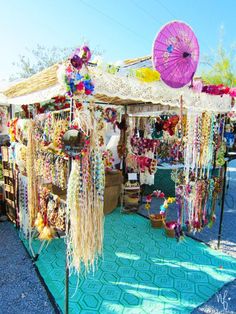 an outdoor market with umbrellas and jewelry