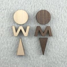 three wooden shapes on a white surface