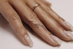 a woman's hand with a small tattoo on it