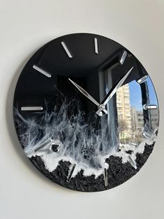 a clock that is on the side of a wall with water and ice around it