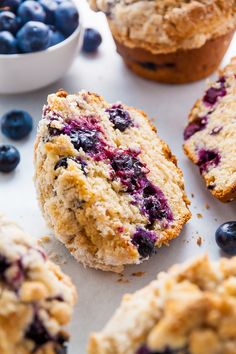 muffins with blueberries are on a white surface