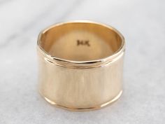 This vintage yellow gold band is absolutely stunning! Also called a cigar band, this ring has a high polish and beautiful shine. The yellow gold has a rich warmth to it that makes the ring all the more eye-catching. Metal: 14K Yellow Gold Width of Band: 12.1 mm Height off Finger: 1.0 mm Ring Size: 6.25 Marks: "14K" Stamped on the inside band Womens Wide Gold Wedding Band, Classic 14k Gold Wide Band Ring For Anniversary, Formal 14k Stamped Wide Band Ring, Timeless Yellow Gold Wide Band Ring, Classic Gold Concave Wide Band Ring, Wide Band Yellow Gold Fine Jewelry, Wide Band In Yellow Gold Fine Jewelry Style, Classic Wide Band Anniversary Bands, Yellow Gold Wide Band Fine Jewelry