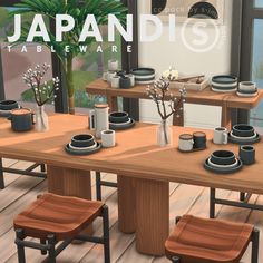 a wooden table topped with lots of plates and cups next to a plant on top of a hard wood floor