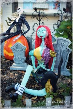 a couple of halloween decorations sitting in the grass