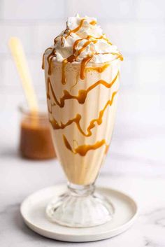 an ice cream sundae with caramel drizzle and whipped cream