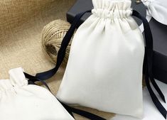 a white bag sitting on top of a table next to some twine