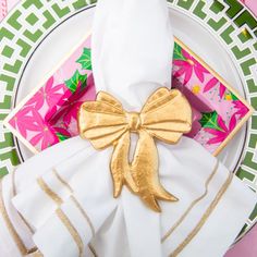 the napkins are wrapped in gold foil and have bows on them, along with other decorative items