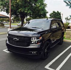 a black suv is parked in the parking lot