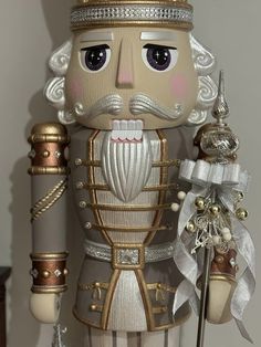 a nutcracker is wearing a crown and holding a cane