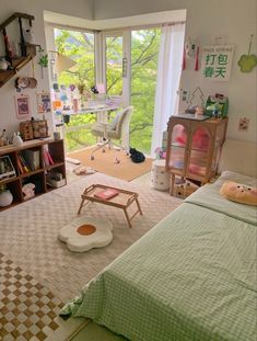 a bedroom with a bed, desk and window overlooking the trees in the distance is shown