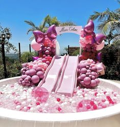 an inflatable pool with pink and purple decorations