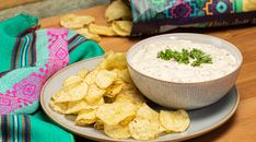 a plate with chips and dip on it