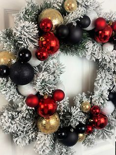 a christmas wreath with red, white and black ornaments