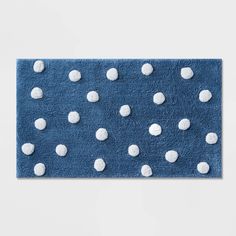 a blue rug with white polka dots on it