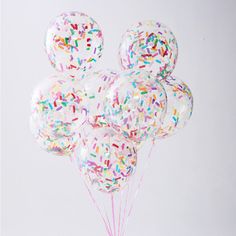 a bunch of balloons with sprinkles on them