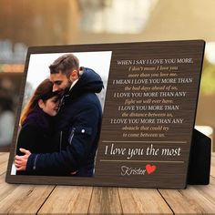 a wooden frame with an image of a couple and the words i love you the most