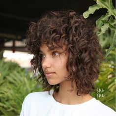 Curly Shag | The shag trend is here to stay. In the age of micro-bangs and unicorn hair, we’re ready to go back—way back—to a classic cut: the shag. Shaggy styles have been back in the limelight this year, for good reason, and the modern shag haircut is still going strong into the fall. We’re not talking Mick Jagger, circa 1972, but rather a nostalgic nod that’s approachable, softer, and absolutely not one-size-fits-all. We rounded up the coolest short shag haircuts to try out this year, and