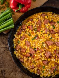 a skillet filled with corn and sausage