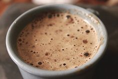 a close up of a cup of coffee on a table