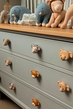 several stuffed animals sitting on top of a dresser