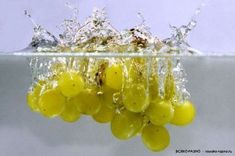 some grapes are falling into the water