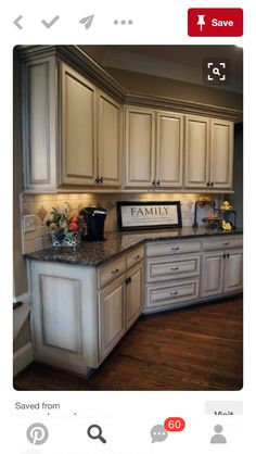 a large kitchen with white cabinets and granite counter tops, along with wooden flooring