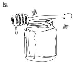 a jar filled with honey sitting next to a wooden spoon